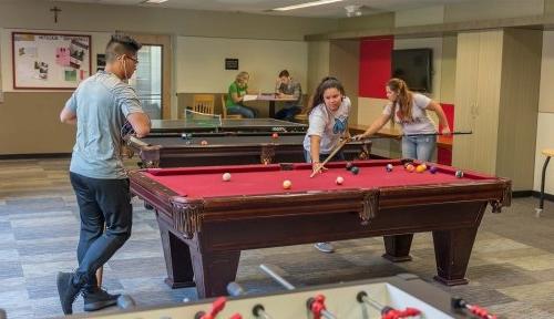 Commuter students playing pool in the Trautman Union Building lounge