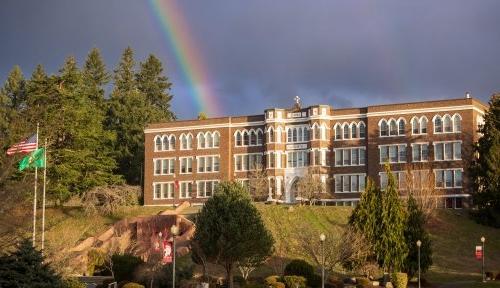Old Main, the primary campus building, sits atop the hill at the end of a rainbow